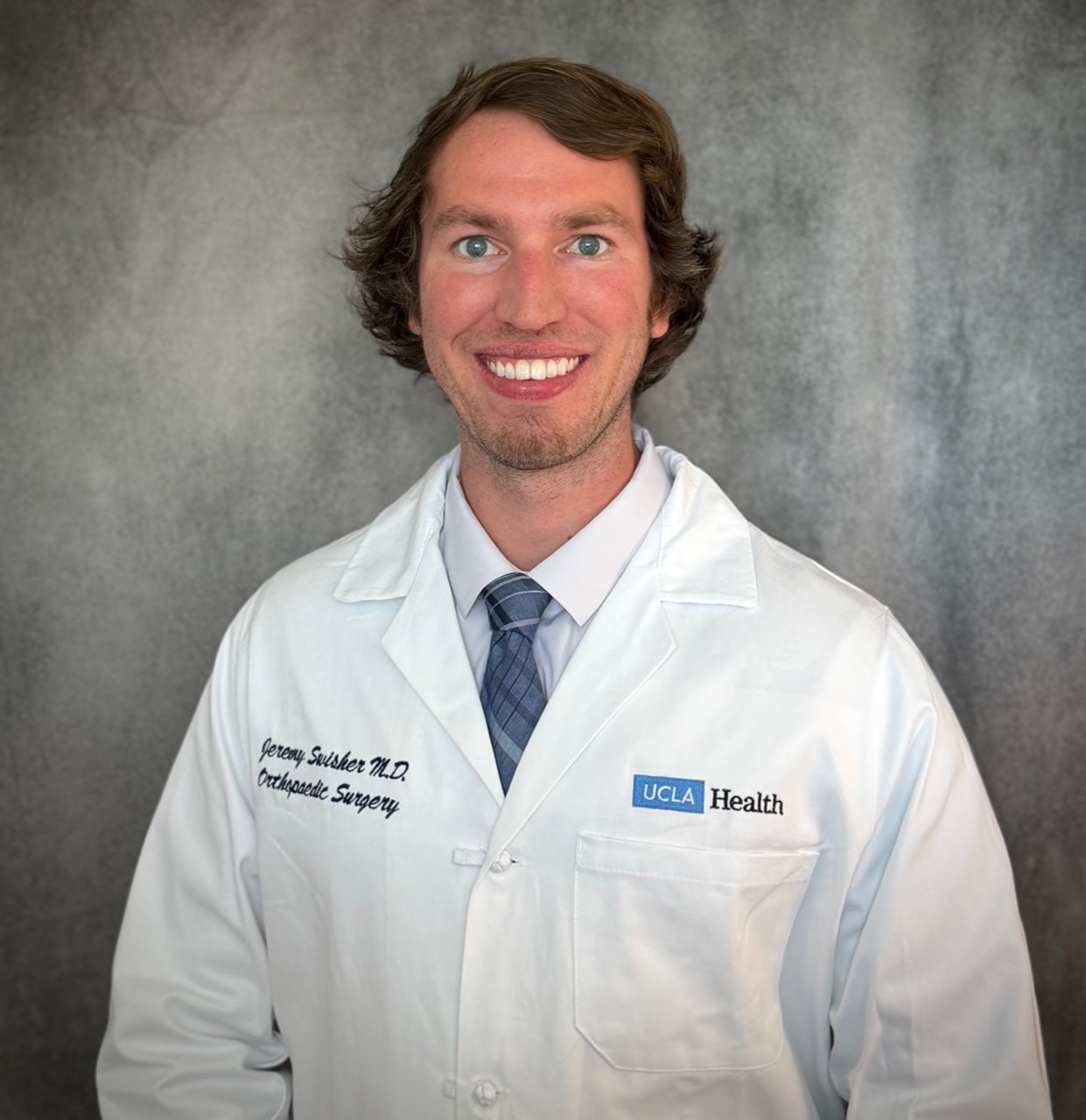 Jeremy Swisher, MD, wearing a UCLA Health white coat